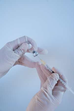 Close-up of a medical professional holding a syringe before vaccination