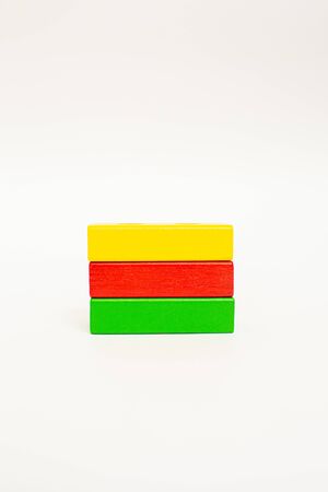 Toy wooden blocks, multicolor building construction bricks looking like Lithuania flag. White background. Early educationの写真素材