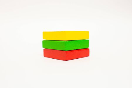 Toy wooden blocks, multicolor building construction bricks looking like Lithuania flag. White background. Early educationの写真素材