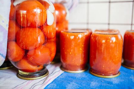 Closeup of canned vegetables in glass jars on the table in the market. Homemade vegetables preserves.の写真素材