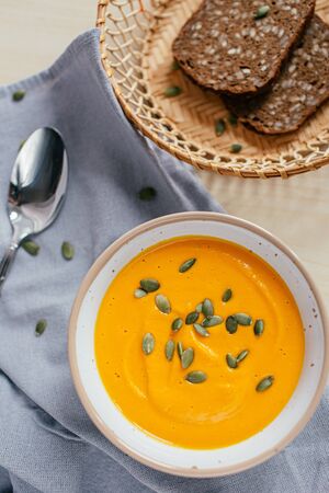 Cream of Pumpkin Soup with toasted bread and pumpkin seeds. Healthy homemade food. Natural food. Vegan diet.の写真素材