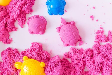 Little Girl Playing with Pink Kinetic Sand at Home. Early Education. Preparing for School. Developmentの写真素材