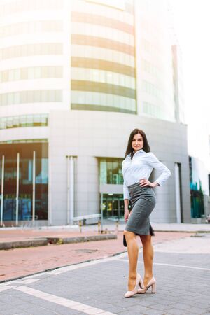 The beautiful woman in suit standing near the business center.の写真素材