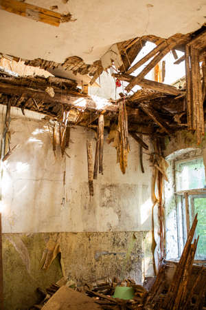 Old ruined laths on broken ceiling roof of a abandoned house