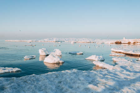 Winter coastal landscape with floating ice. Baltic sea in evening light.の写真素材
