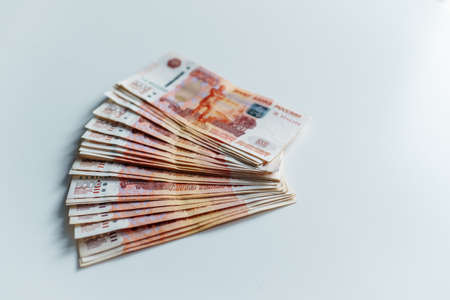 Banknotes of five thousand russian rubles lying on white table. Top view.の写真素材