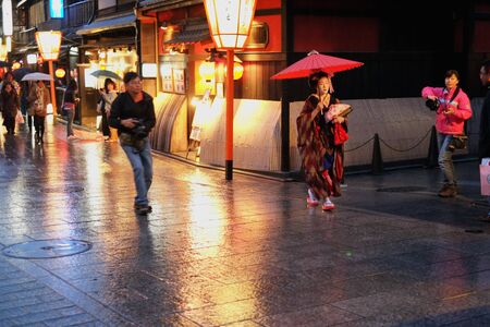 Kyoto, Japan - April 8, 2013: Tourists turn into paparazzi to capture the elusive Geisha who moves fast, silently and choreographically perfect.のeditorial素材