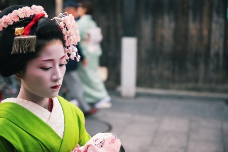 Kyoto, Japan - April 8, 2013: Geisha approaching a tea house in the Gion district of Kyoto. The Geisha in Gion are the highest ranked in Japan.のeditorial素材