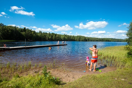Norrkoping, Sweden - August 4, 2013  Summer in Sweden - people enjoying a sunny day by a lakeのeditorial素材