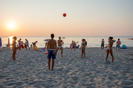 Cefalu, Sicily, Italy - July 16, 2013  Tourists play volleyball on the beach in Cefalu at sunset  Cefalu is one of the most popular destinations for a Sicilian vacation のeditorial素材