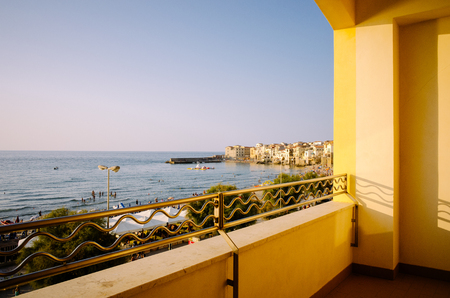 Cefalù, Sicily, Italy  July 16, 2013  View from a terrace of the beach and the old town in Cefalù, Sicily  Cefalù is one of the most popular destinations for a Sicilian vacation のeditorial素材