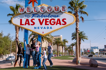 Las Vegas, Nevada, USA - April 7, 2011  Group of female tourists jump of joy at the Las Vegas sign   のeditorial素材