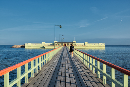 Malmo, Sweden  August 21, 2013  A young woman enters the Ribersborg open-air bath in Malmo, Sweden  This vintage public bath was inaugurated in 1898 and has remained popular among the citizens of Malmo のeditorial素材