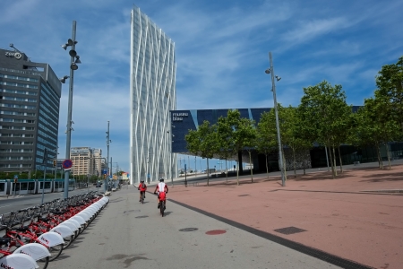 Barcelona, Spain - June 7, 2013  Bikers pass a bike sharing station near Museo Blau and Barcelona International Convention Center CCIBのeditorial素材