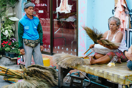 Hua Hin, Thailand  February 14, 2013  Thai brush salesman displays his products for a Thai woman in Hua Hin  Hua Hin is a major tourist destination in Thailand のeditorial素材