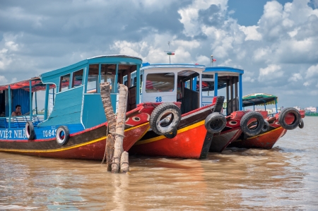Vinh Long, Vietnam - March 6, 2009  Traditional colorful riverboats on Mekong river near Vinh Long  The Mekong river is a major route for transportation in Southeast Asia のeditorial素材