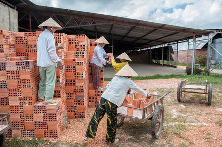 Vinh Long, Vietnam - March 7, 2009  Vietnamese women work in an old brickworks in the Mekong delta  The Mekong delta has become popular among tourists wishing to experience rural Vietnam のeditorial素材