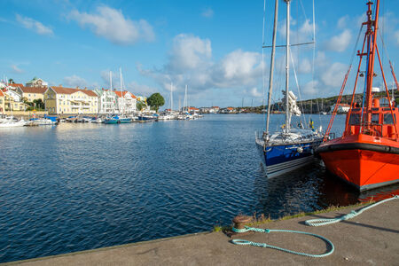 Marstrand, Sweden  July 2, 2014  Pilot boat and sailboat moored at a quay in Marstrand  Located on two islands in the archipelago north of Gothenburg Marstrand is a fishing village and a popular tourist destination のeditorial素材