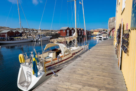 Smogen, Sweden - September 3, 2014: Sailboat moored at the boardwalk in Smogen. Smogen is a famous fishing village and popular tourist destination.のeditorial素材
