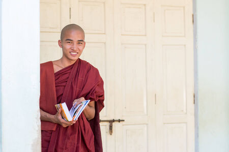 Bagan, Myanmar - February 8, 2014: Young Burmese novice monk studies a book. Buddhists in Myanmar belong mainly to the Thervada tradition.のeditorial素材