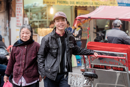 Hanoi, Vietnam - February 10, 2015: Rickshaw driver waits for customers in the old quarter of Hanoi. The 36 old streets and guilds of the old quarter are a major tourist attraction.のeditorial素材