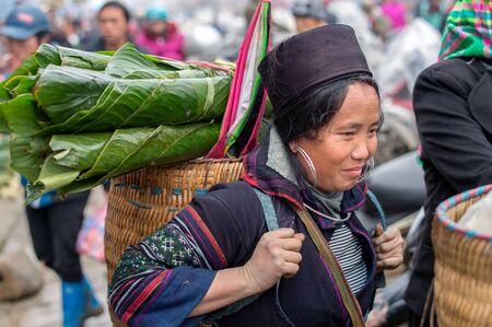 Sapa, Vietnam - February 13, 2015: Hmong woman at a market in Sapa. Sapa is famous for its rugged scenery and its rich cultural diversity. Hmong people is one of many  colorful tribes.のeditorial素材