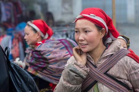 Sapa, Vietnam - February 13, 2015: Red Dao women in a village outside Sapa. Sapa is famous for its rugged scenery and its rich cultural diversity. Red Dao people is one of many a colorful tribes.のeditorial素材