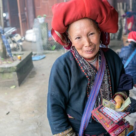 Sapa, Vietnam - February 13, 2015: Red Dao woman in a village outside Sapa. Sapa is famous for its rugged scenery and its rich cultural diversity. Red Dao people is one of many a colorful tribes.のeditorial素材