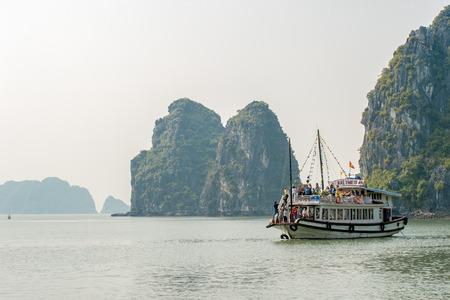 Halong Bay, Vietnam - February 16, 2015: Tour boat cruises in Halong Bay. With its 1600 islands and islets Hanlong Bay is a Unesco World Heritage site and a major tourist destination in northern Vietnam.のeditorial素材
