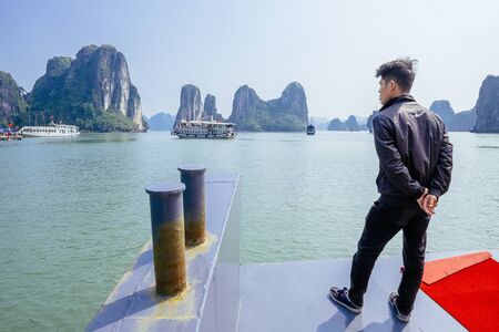 Halong Bay, Vietnam - February 16, 2015: Tour boats cruise in Halong Bay. With its 1600 islands and islets Hanlong Bay is a Unesco World Heritage site and a major tourist destination in northern Vietnam.のeditorial素材