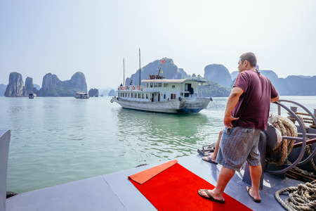 Halong Bay, Vietnam - February 16, 2015: Tour boats cruise in Halong Bay. With its 1600 islands and islets Hanlong Bay is a Unesco World Heritage site and a major tourist destination in northern Vietnam.のeditorial素材