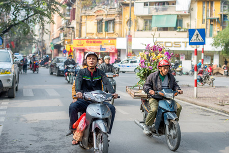 Hanoi, Vietnam - February 15, 2015: Motorbike traffic in the old quarter of Hanoi. There are approximately four million motorbikes on the streets of Hanoi.のeditorial素材