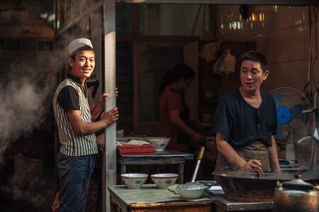 Xian China  June 20 2012: Hui muslims prepare street food at famous Muslim Street in Xian. Hui people are a Muslim ethnic minority in Xian and run a lively market at Muslim Street.のeditorial素材