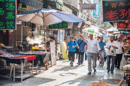 Xian China  June 20 2012: Chinese tourists and Hui people stroll at famous Muslim Street in Xian. Hui people are a Muslim ethnic minority in Xian and run a lively market at Muslim Street.のeditorial素材