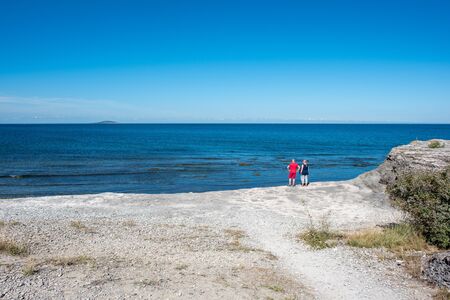 Byrum, Sweden  August 16, 2015: Tourists at Byrum on Oland enjoy the view of the Baltic Sea and island Blue Virgin. Oland is a popular tourist destination in Sweden.のeditorial素材