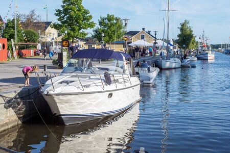 Trosa, Sweden  August 6, 2015: Leisure boats moored at the harbor along the outflow of Trosa river into the Baltic sea. Trosa is an idyllic and historic seaside town south of Stockholm and a popular tourist destination during summer time.のeditorial素材