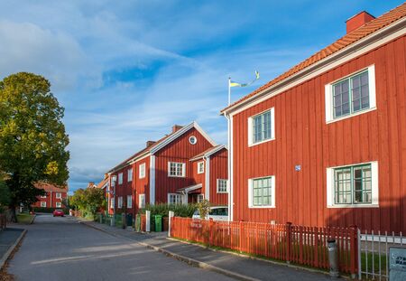 Norrkoping, Sweden - October 15, 2010: Red city during autumn in Norrkoping. This is a picturesque residential area with old red wooden houses in Norrkoping, which is a historic industrial town.のeditorial素材