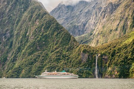 Milford Sound, New Zealand  February 14, 2012: Cruise ship cruising in Milford Sound. This fiord is considered as one of the most scenic places in the world.のeditorial素材