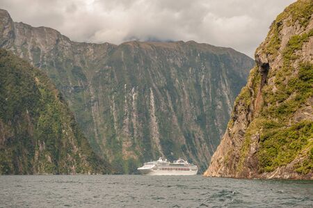 Milford Sound, New Zealand  February 14, 2012: Cruise ship cruising in Milford Sound. This fiord is considered as one of the most scenic places in the world.のeditorial素材