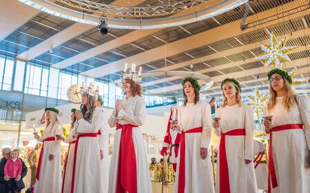 Norrkoping, Sweden - December 13, 2015: Lucia celebration in a mall in Norrkoping. The celebration of Lucia or Saint Lucy is one of the dearest traditions in Sweden before Christmas.のeditorial素材