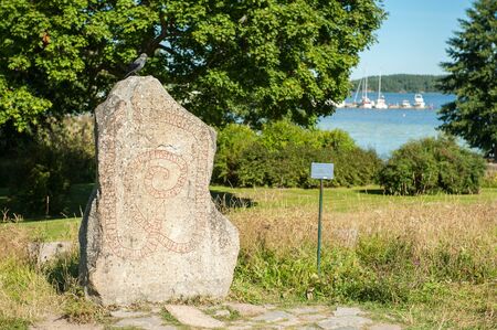 Viking rune stone during summer in idyllic small town Mariefred. This historic town on Lake Malaren is a popular tourist destination in Swedenの写真素材