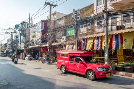 Chiang Mai, Thailand - February 3, 2016: Iconic traditional red truck taxi roaming the streets of Chiang Mai. Chiang Mai is a major tourist destination in northern Thailand.のeditorial素材