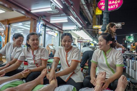 Bangkok, Thailand - February 24, 2016: Thai women provide foot massage to tourists at the sidewalks of  Khao San Road in Bangkok.  Khao San Road is a world famous backpacker street.のeditorial素材