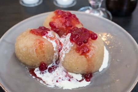 Kroppkakor is a traditional dish on Swedish Baltic sea island Oland. It is a type of potato dumpling filled with onions and pork or bacon and often served with cream and lingonberries.の写真素材