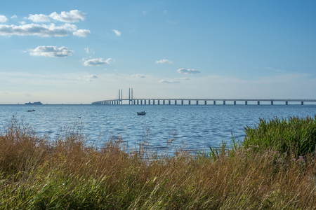 Oresund and Oresund Bridge viewed from Bunkeflostrand in Malmo, Sweden on a sunny summer day.の写真素材