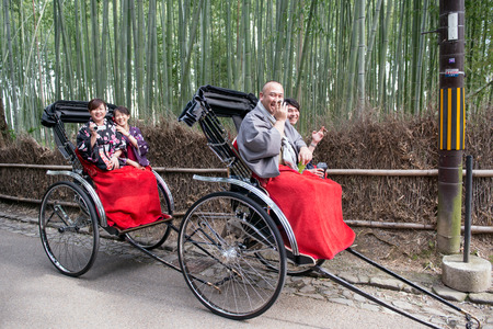 Arashiyama, Japan - April 4, 2013: Traditional hand pulled rickshaw in Sagano Bamboo Forest in Arashiyama at the outskirts of Kyoto, Japan. Arashiyama has been a popular destination since the 8th century.のeditorial素材