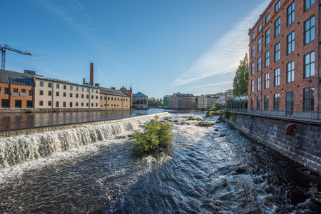 Norrkoping, Sweden - May 20, 2018: Motala river and the industrial landscape during summer in...