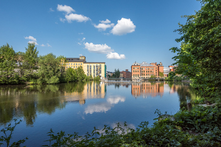 Norrkoping, Sweden - May 23, 2018: Motala river and the industrial landscape during summer in...