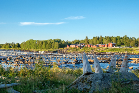 View from the Swedish side of Kukkola rapids across Torne river towards Finland on a summer day in August 2018. Kukkola rapids has been a fishing site since medieval times.の写真素材