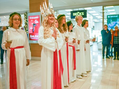 Norrkoping, Sweden - December 13, 2019: Traditional celebration of Saint Lucy in Sweden. Norrkopingâs Lucia 2019 Izabella Swartz singing Christmas carols in shopping mall Linden.のeditorial素材